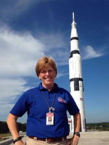 Ruth Marie Oliver (Red Bull) on the Roof of the USSRC with the Saturn V in the Background