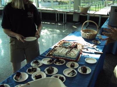 20th Anniversary - Counselor Serves Space Camp Cake